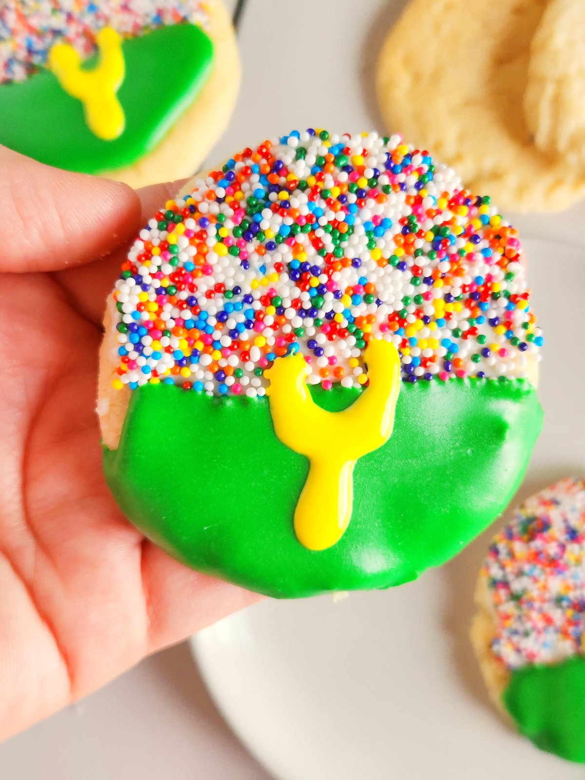 hand holding a football stadium cookie