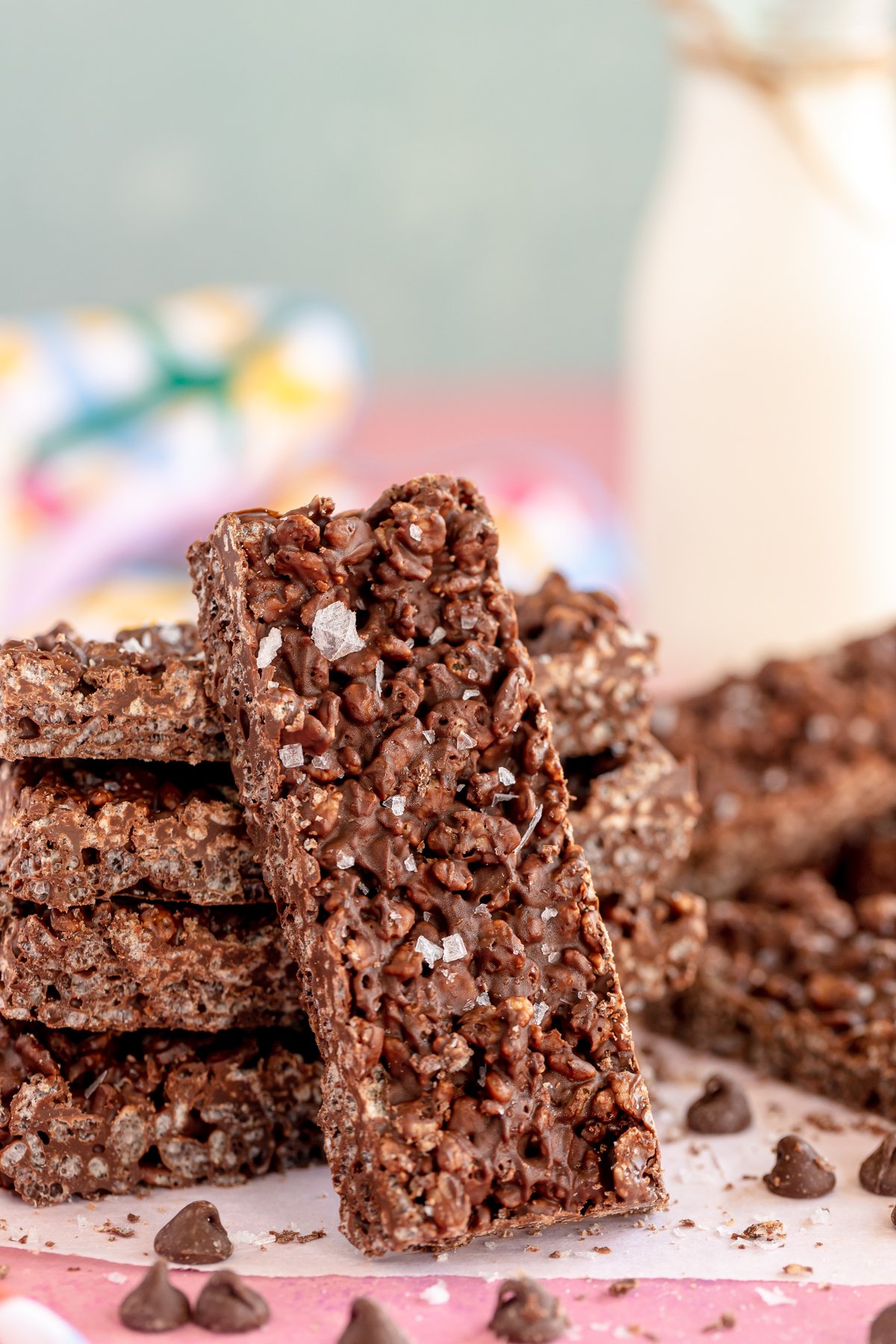 Stack of homemade Nestle crunch bars on a pink background