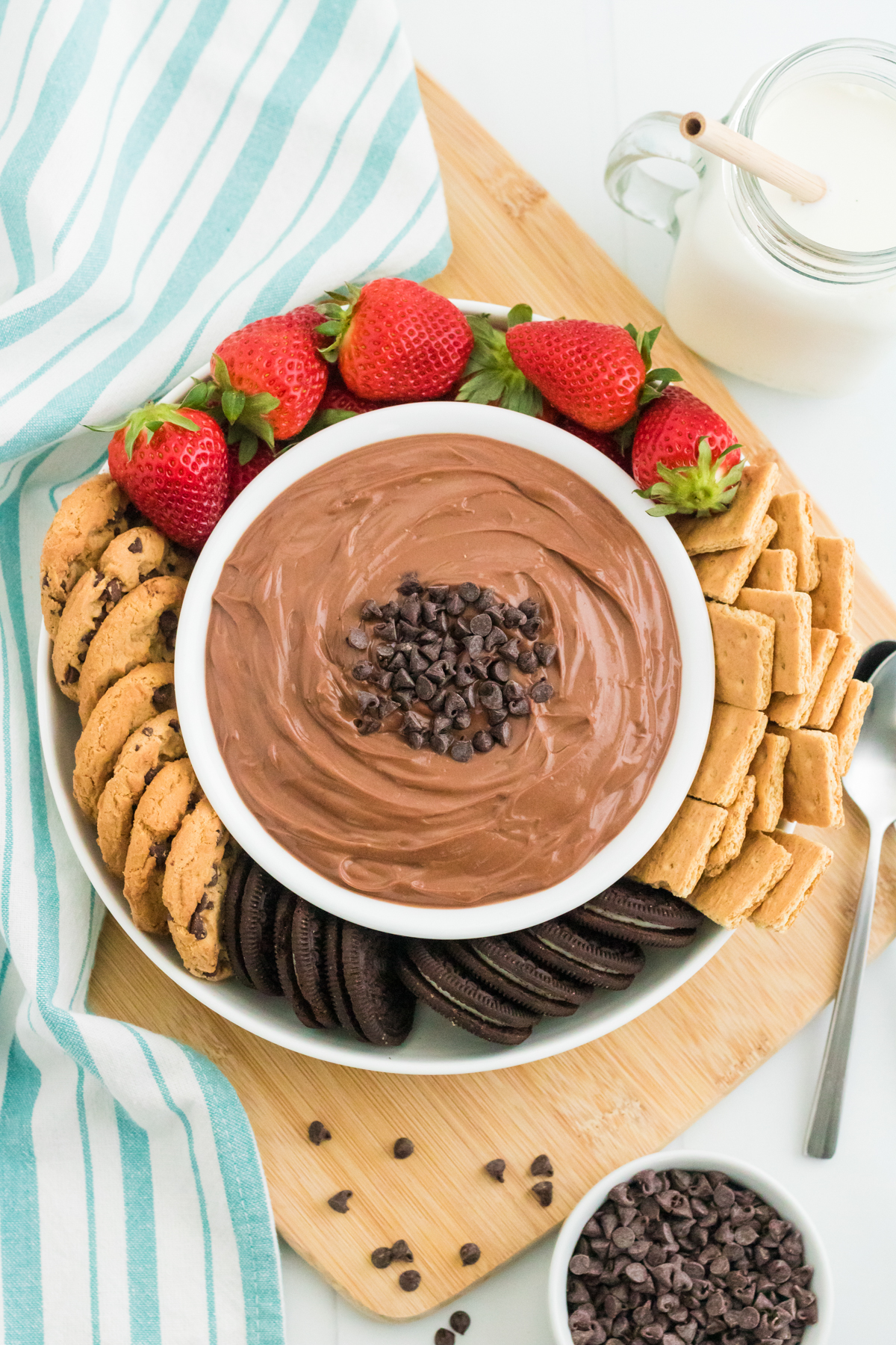 bowl full of nutella dip with fruit, cookies, and crackers