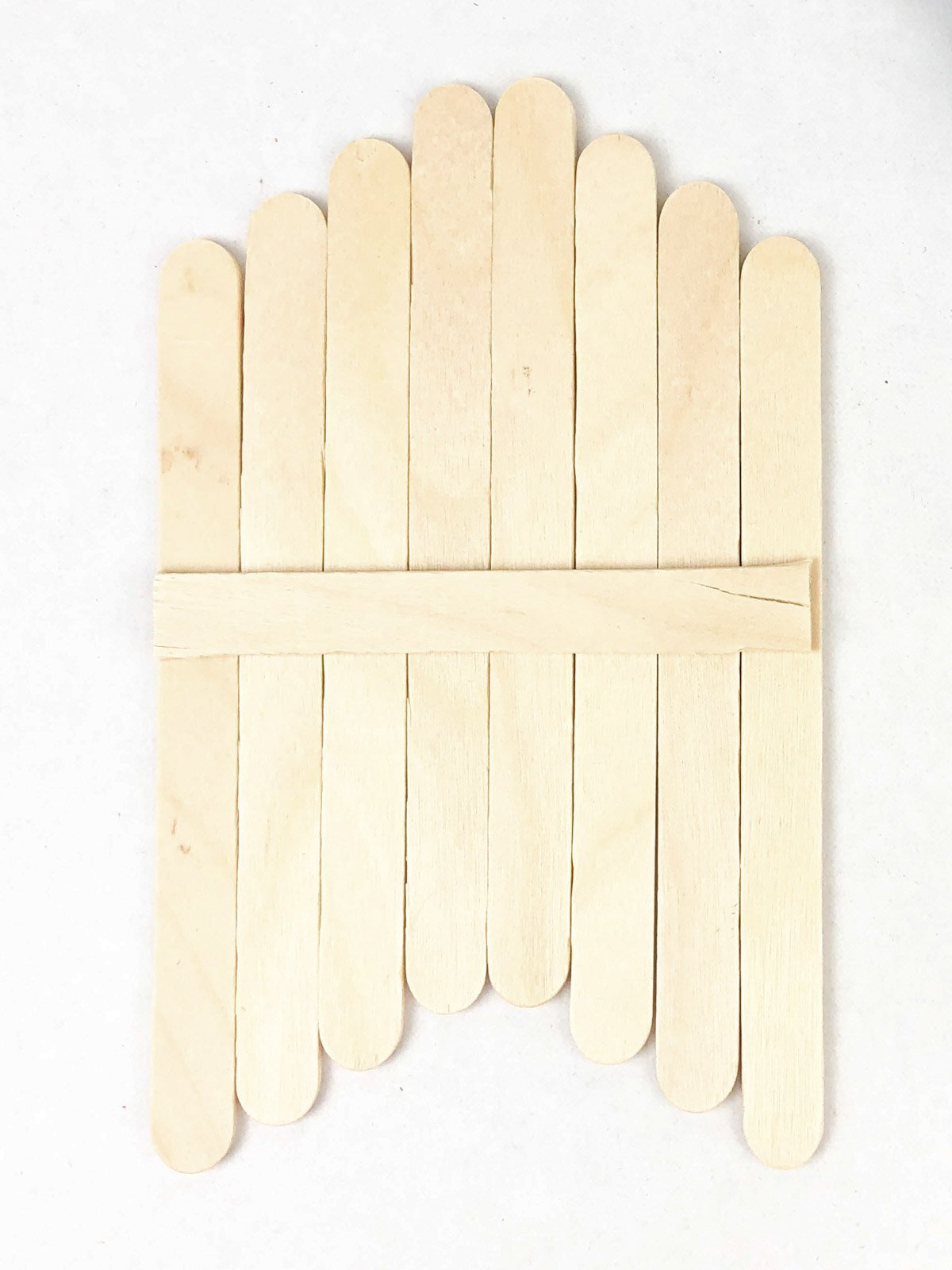 popsicle sticks lined up with one on the back