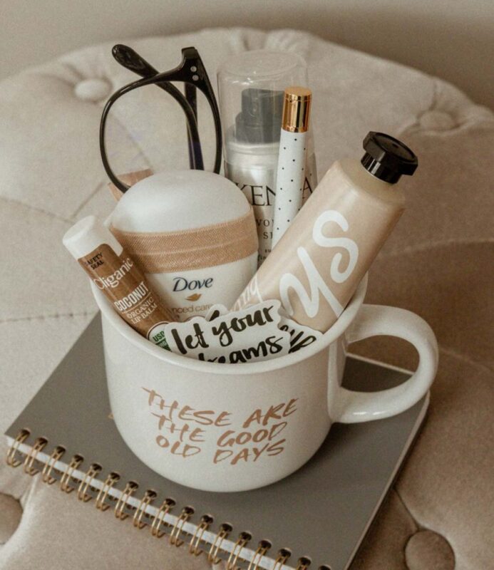 mug filled with small personal items like lotion and chpsticl