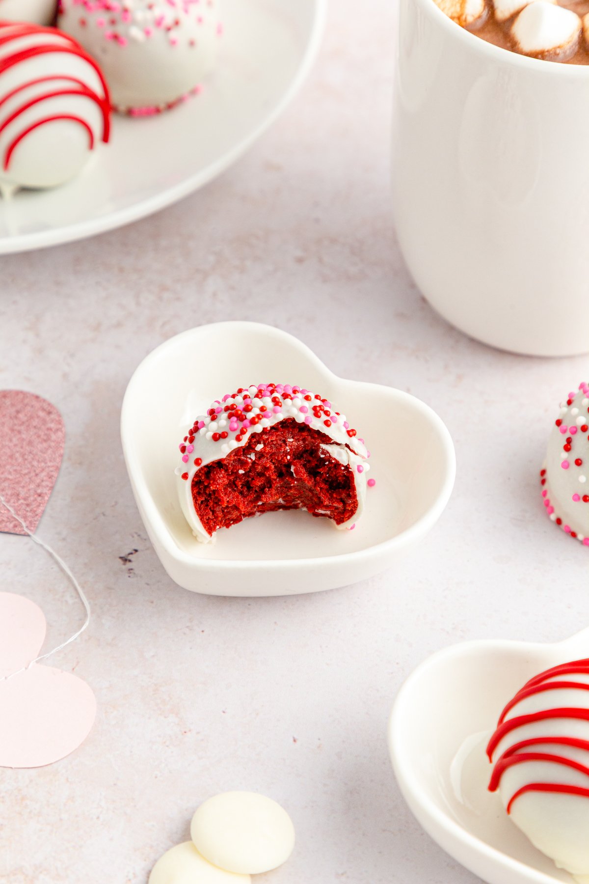 half eaten red velvet cake ball in a plate