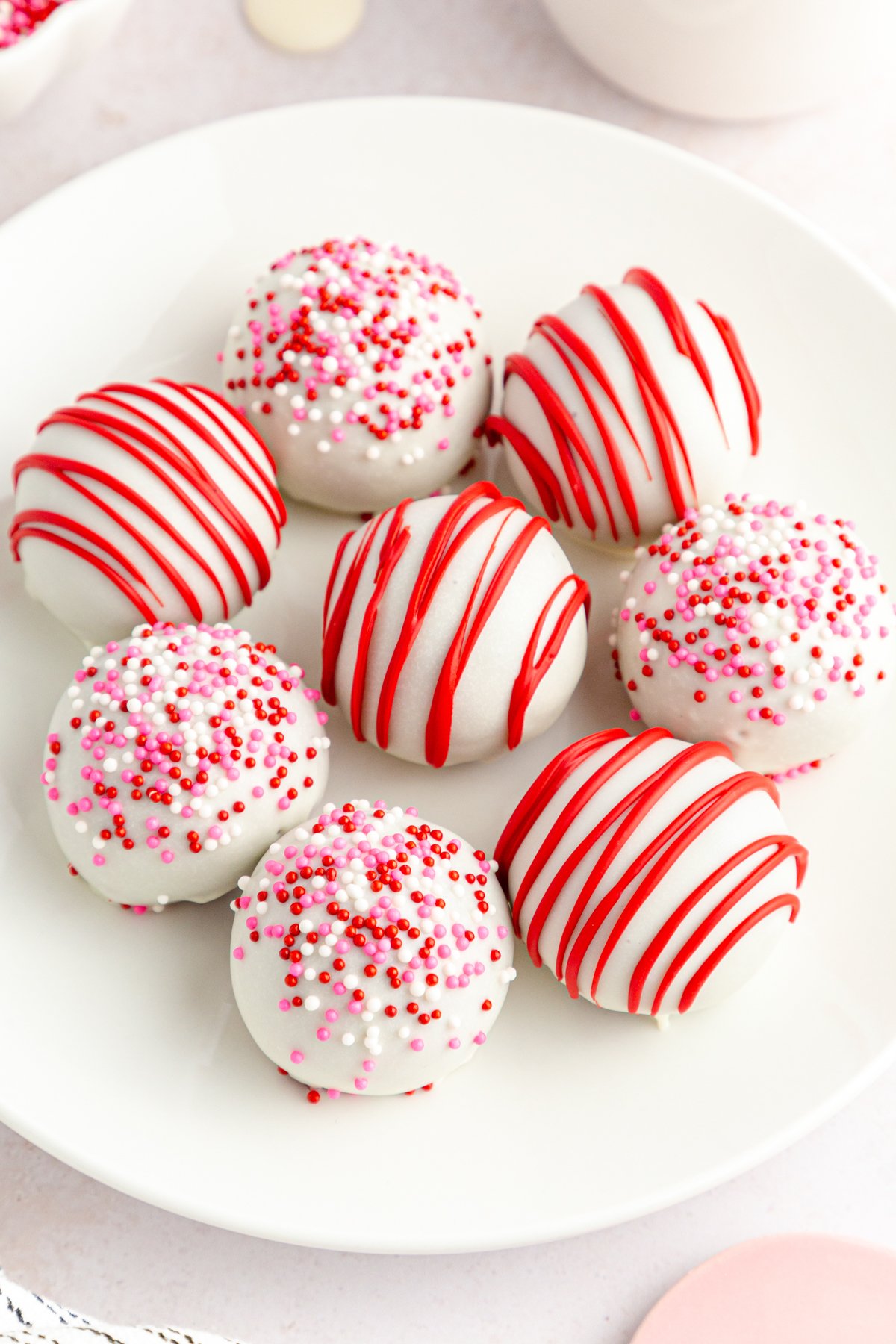 white plate with decorated red velvet cake balls