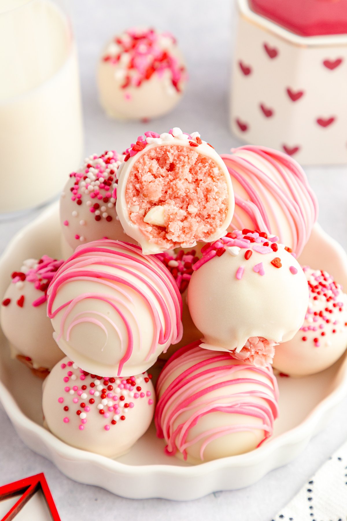 white plate with a stack of strawberry cake balls