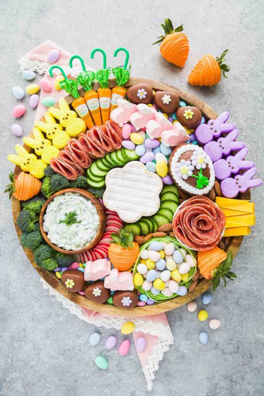 round board with varitey of sweet and savory snacks plus easter candies
