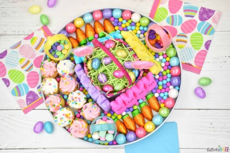brightly colored tray with various easter candies and easter basket center