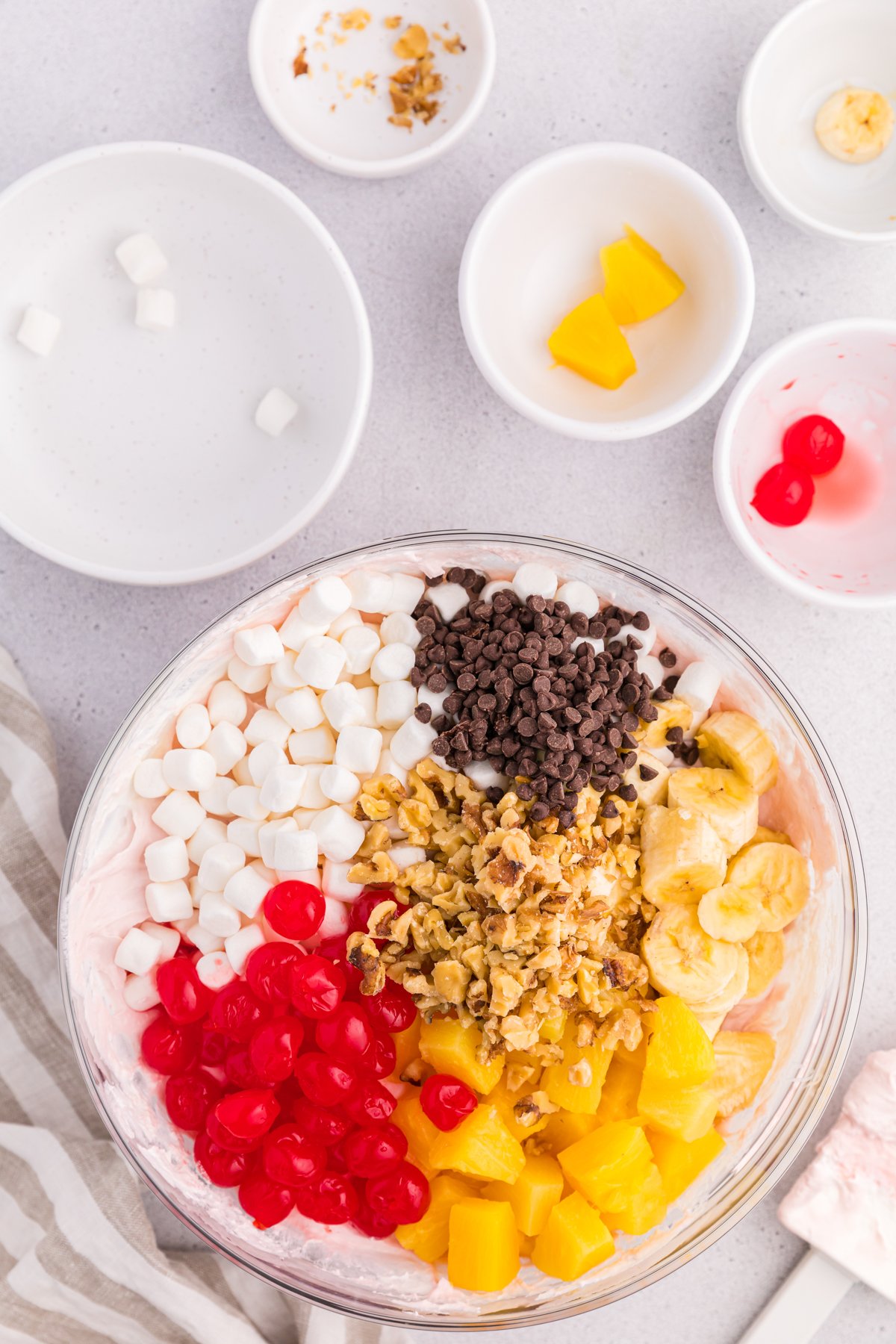 glass bowl with ingredients for banana split fluff