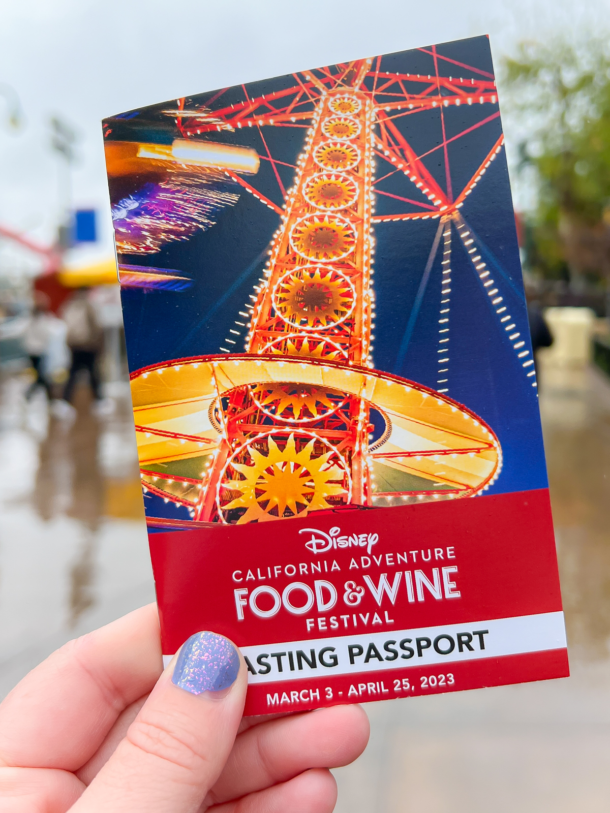 hand holding a tasting passport from the Disney food and wine festival in 2023