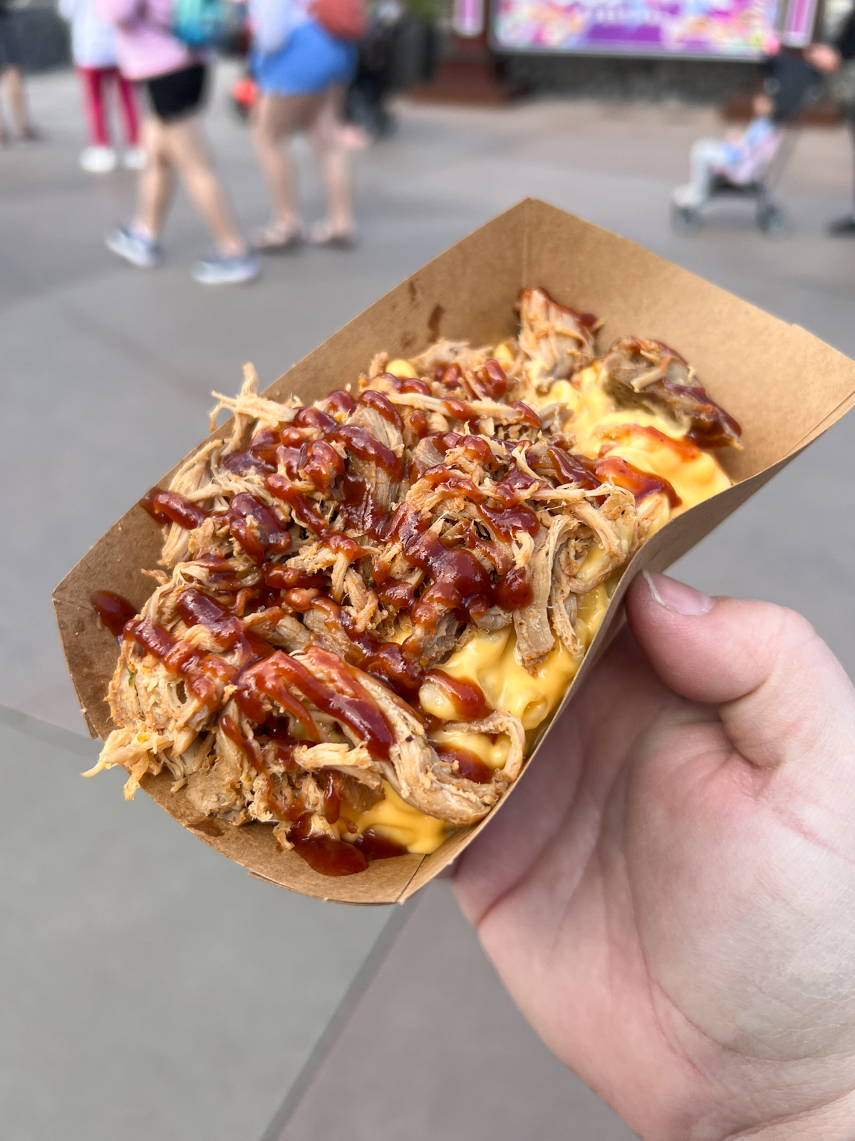 tray of BBQ pulled pork mac and cheese in someone's hand
