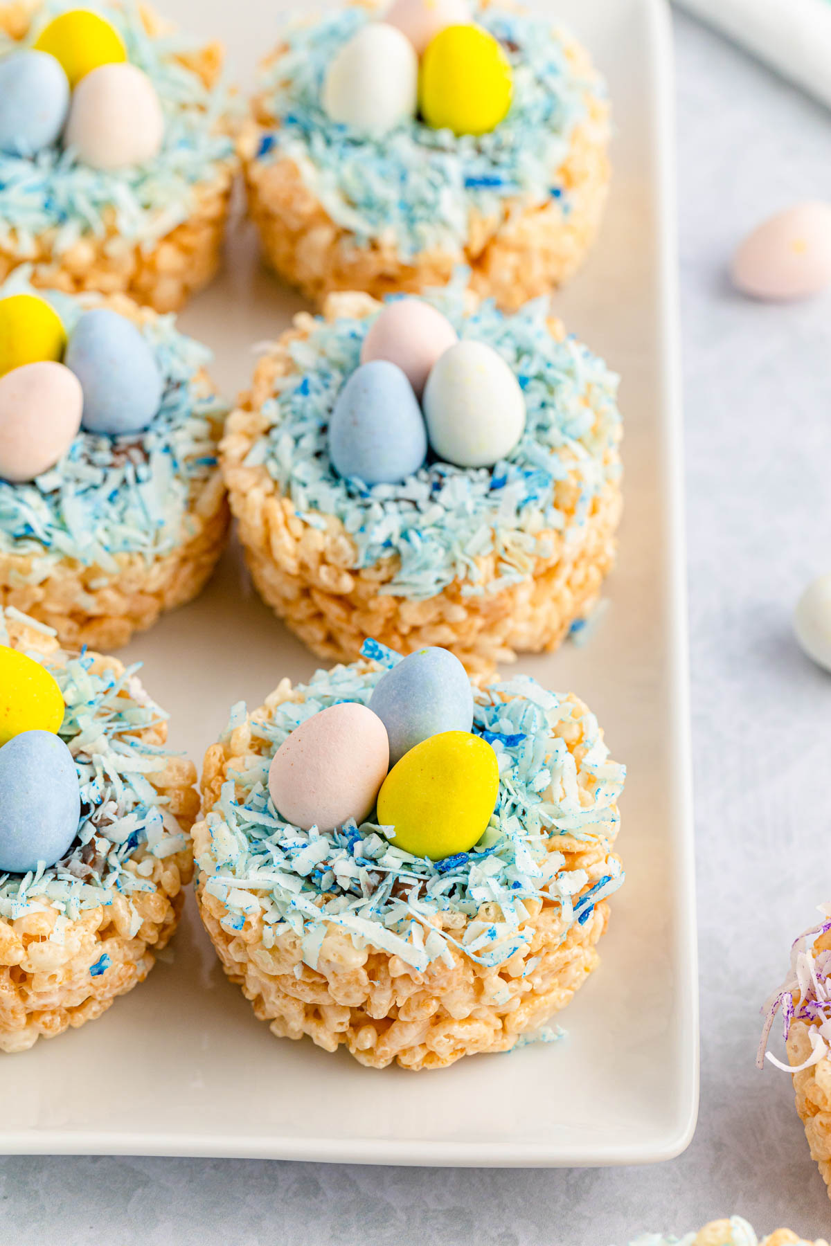 white plate with Easter rice krispie nests with mini cadbury eggs