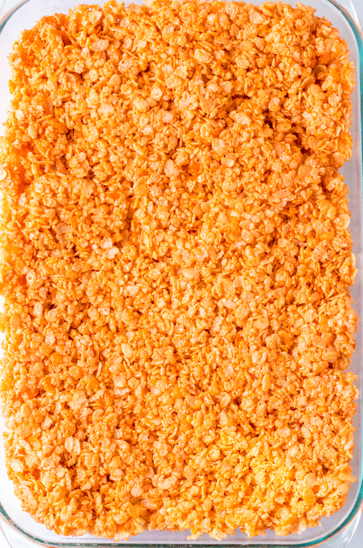 orange rice krispy treats in a pan