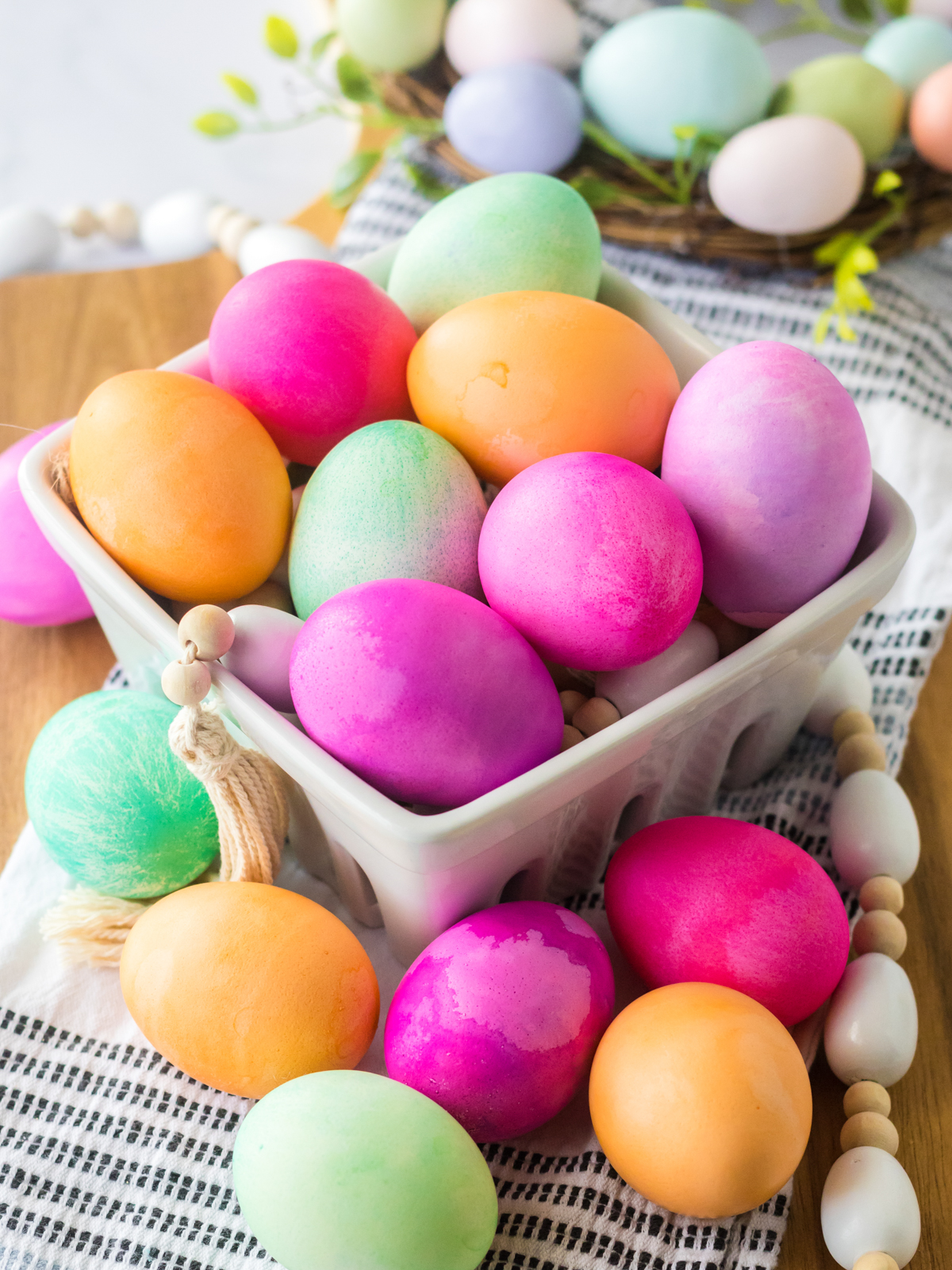 bowl with eggs dyed with food coloring in various colors