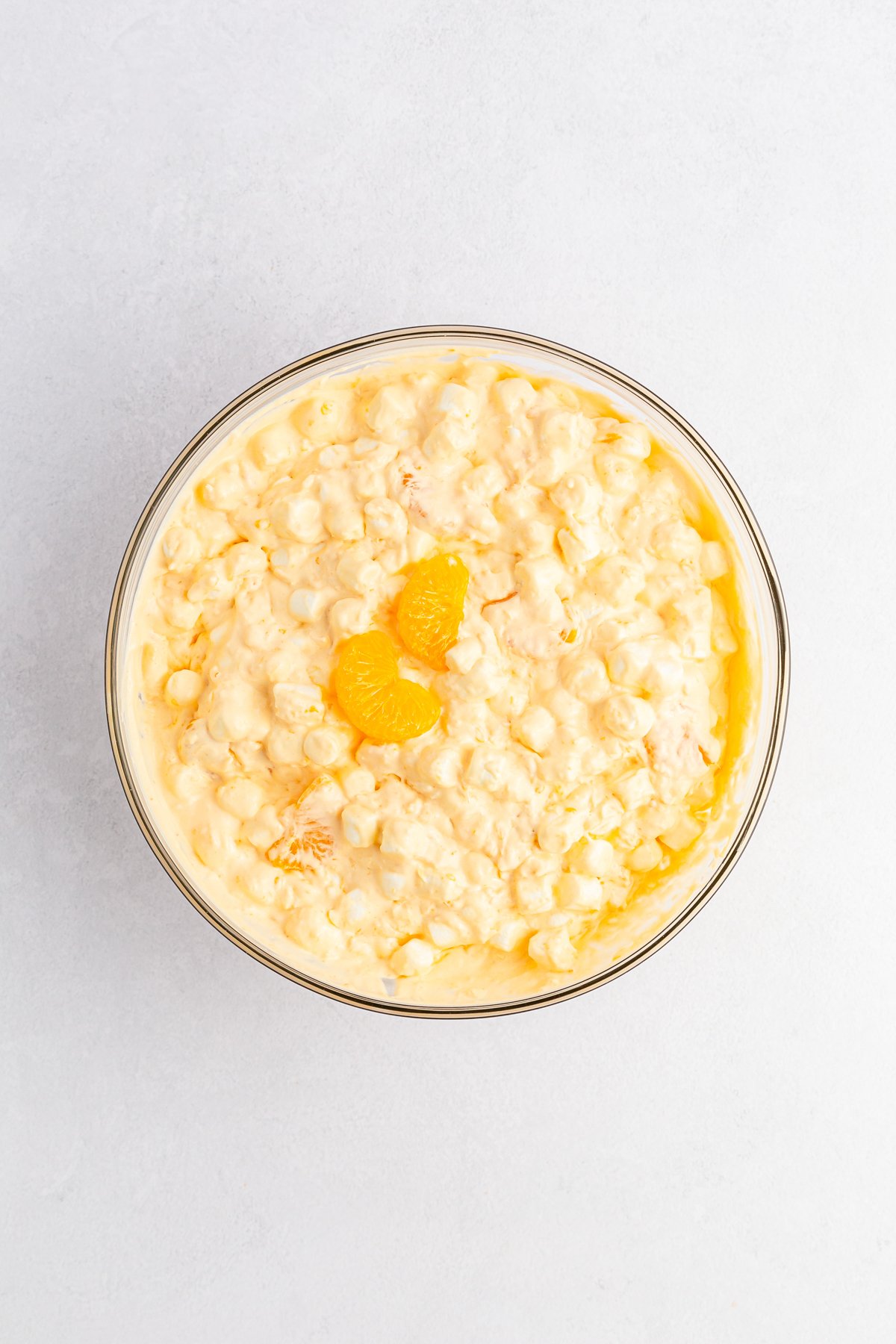 glass bowl with orange fluff salad