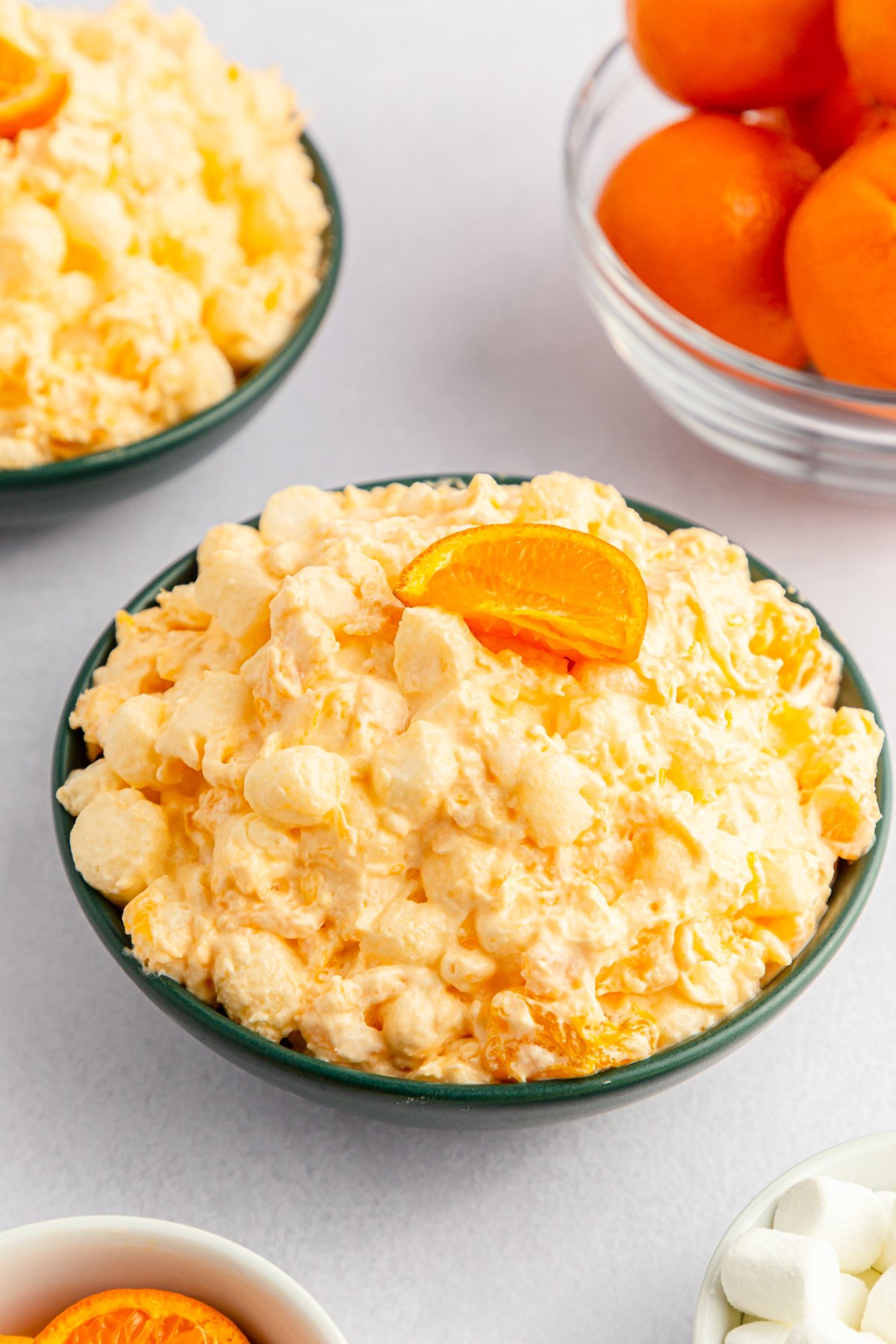 black bowl filled with orange fluff salad