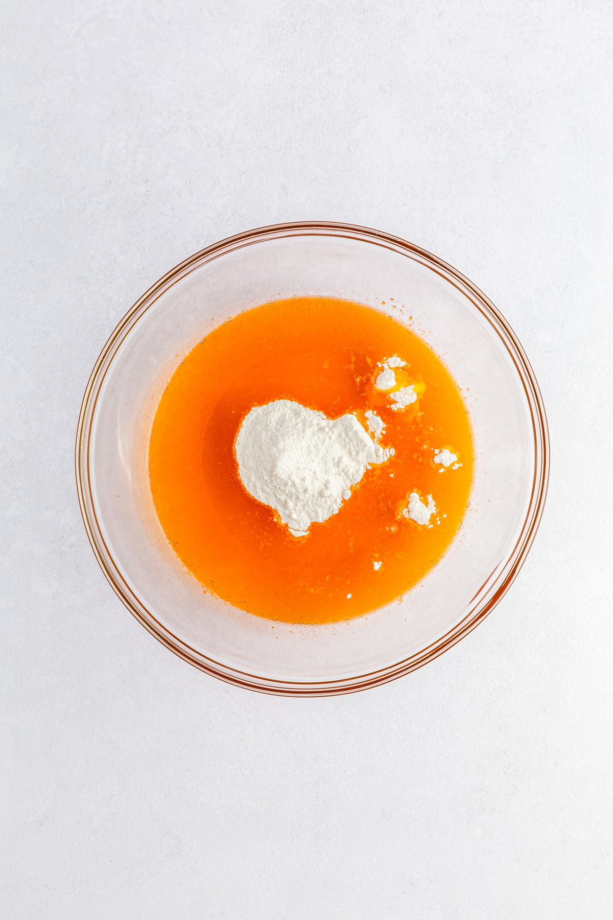 glass bowl with orange jello and pudding