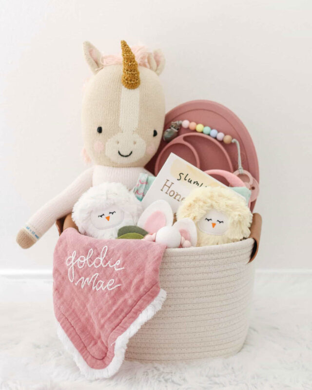 white basket with blanket and soft toys