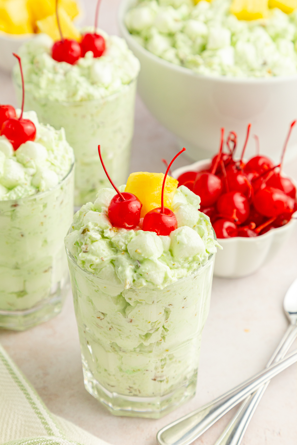 glass cup with watergate salad topped with cherries