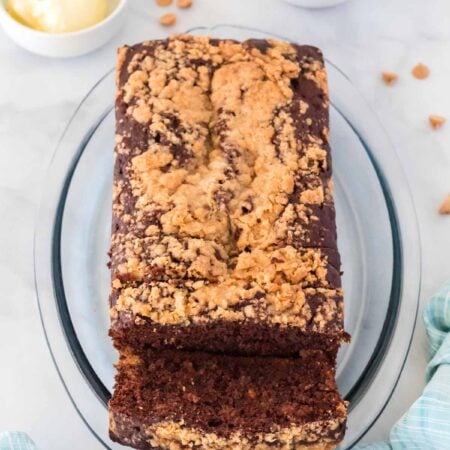 glass plate with a loaf of peanut butter banana bread