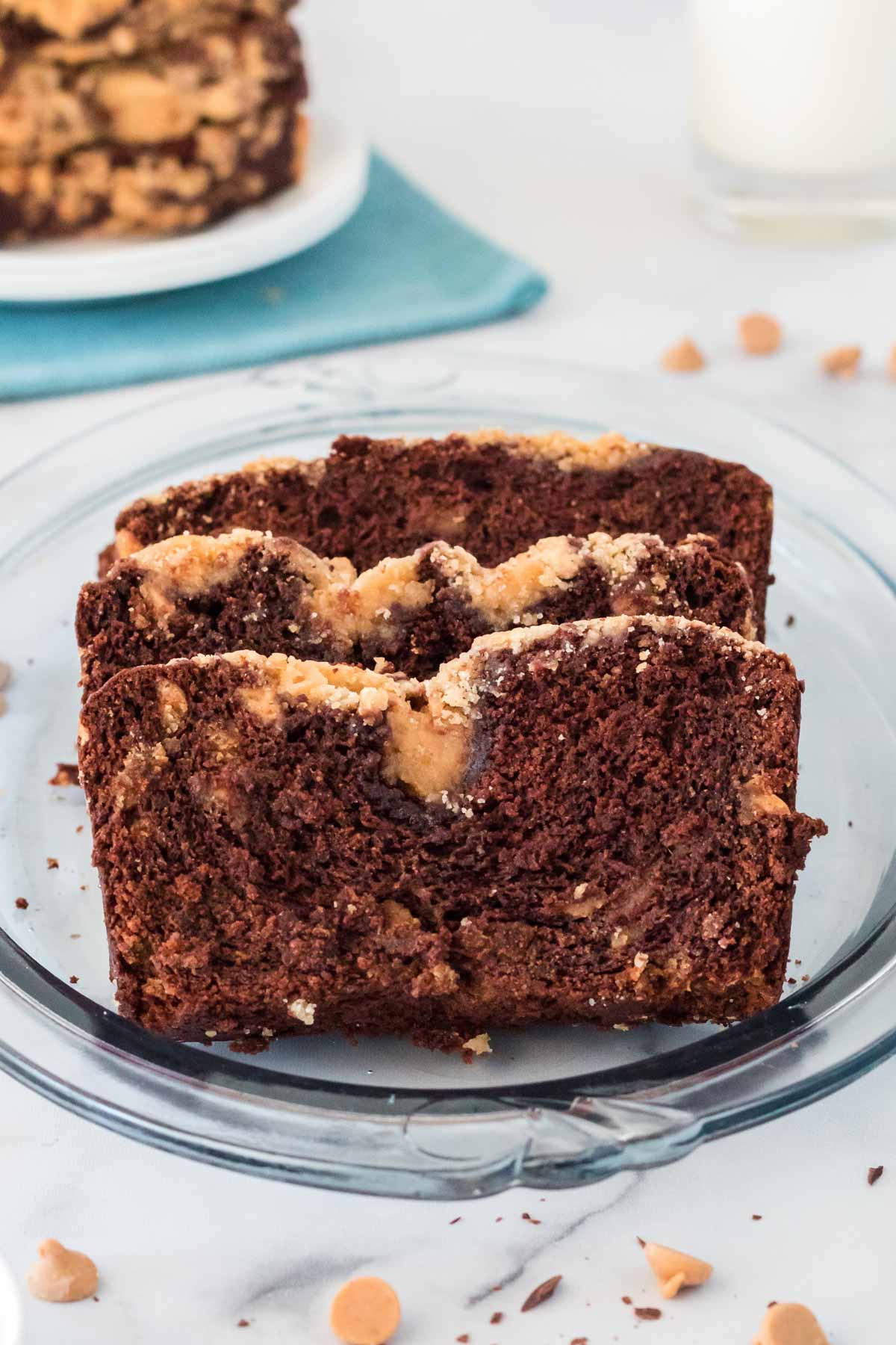 three slices of peanut butter banana bread on a glass plate