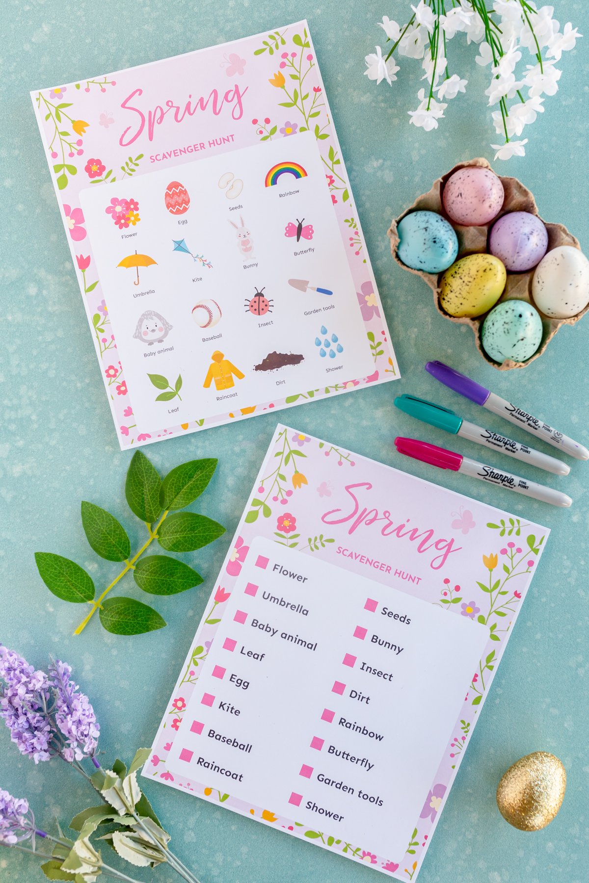 two printed out spring scavenger hunt copies with spring items all around