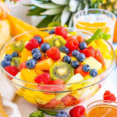 tropical fruit salad with tropical props in the background