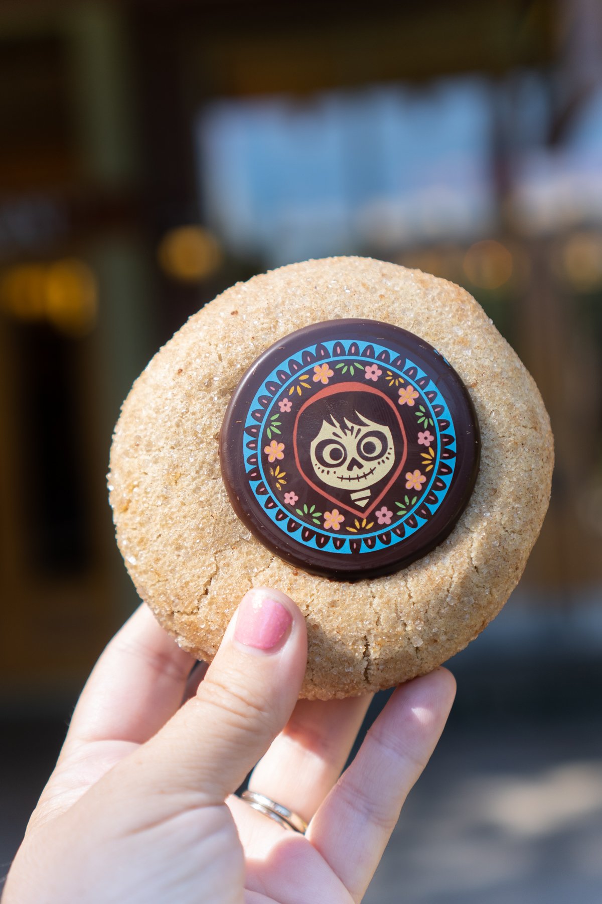 hand holding an horchata cookie with a Coco logo