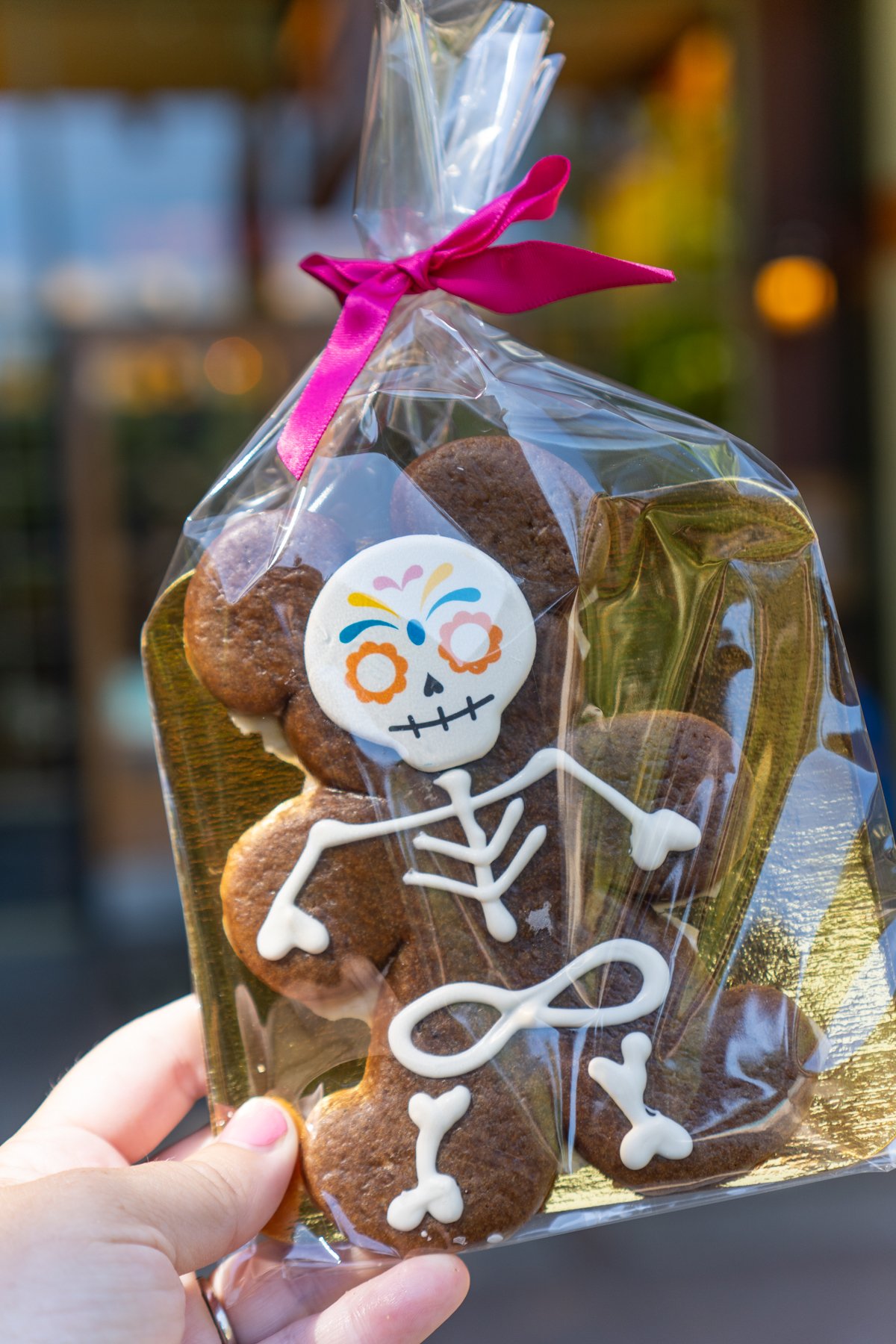 hand holding a packaged skeleton gingerbread man