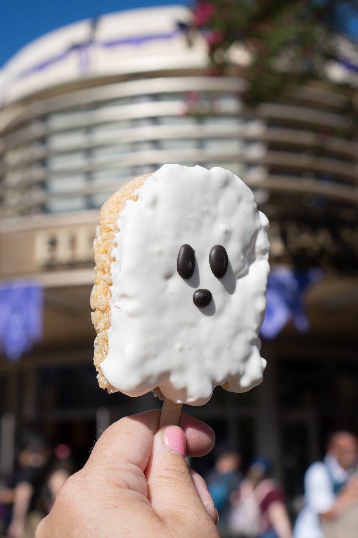 hand holding a rice krispy treat shaped like a ghost