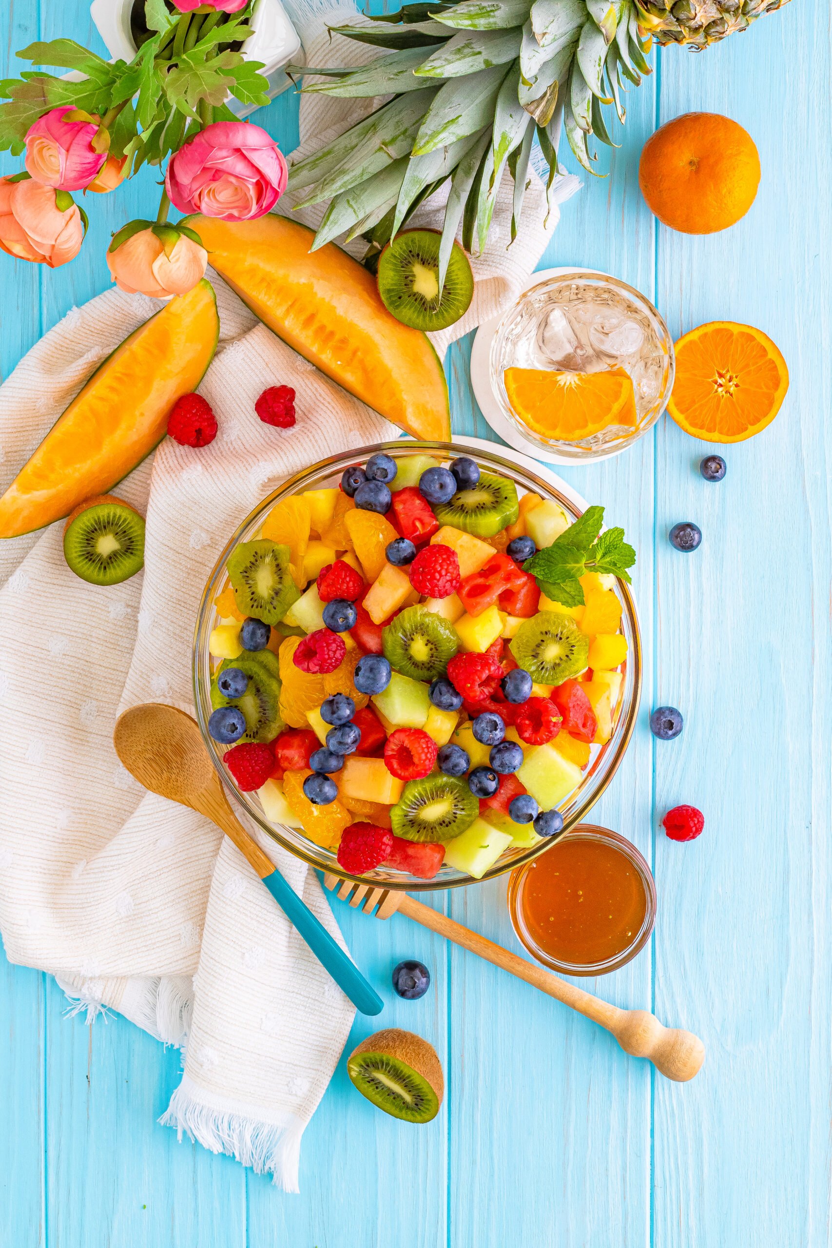 top down view of a tropical fruit salad in a glass bowl