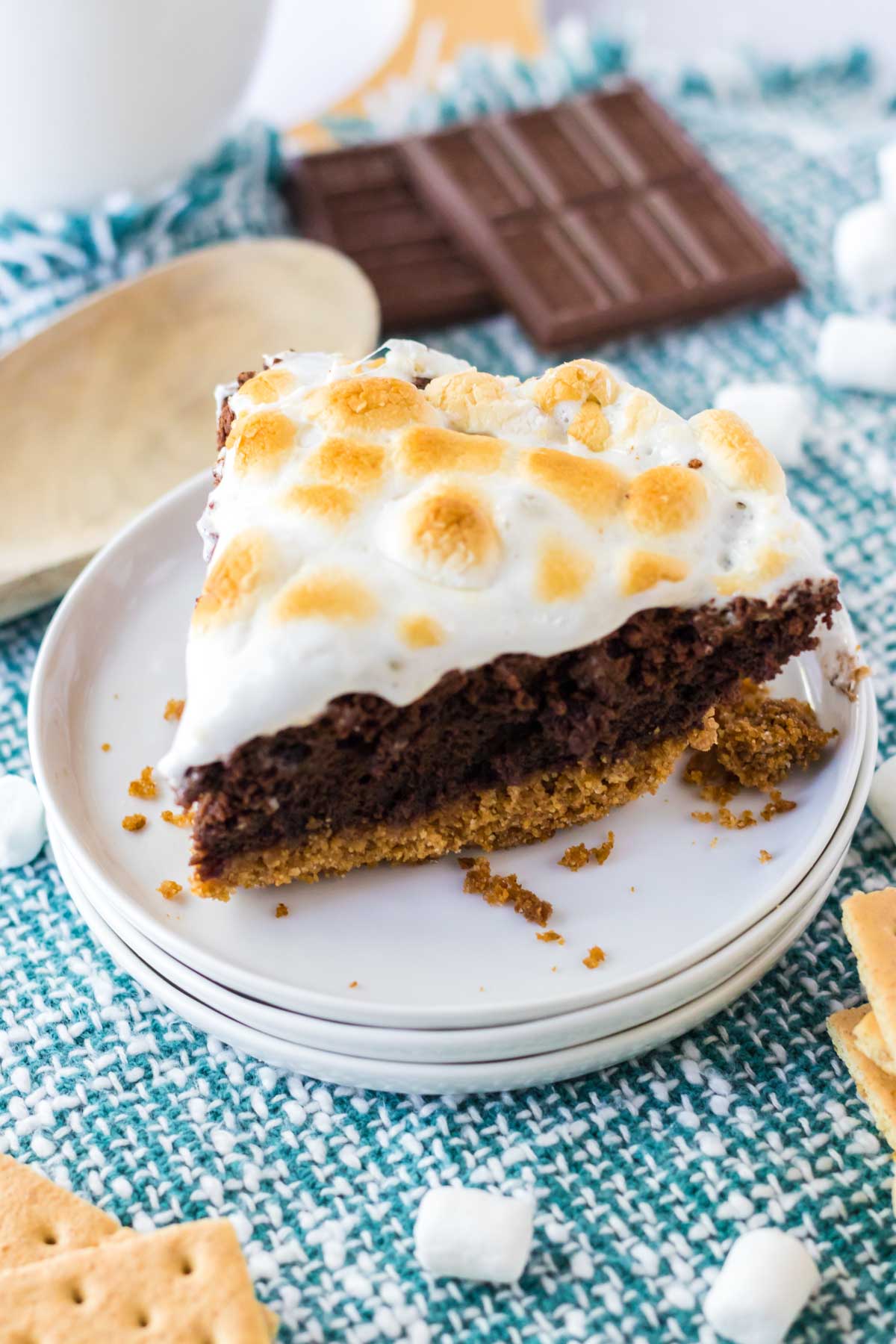 Slice of s'mores brownie pie on a white plate