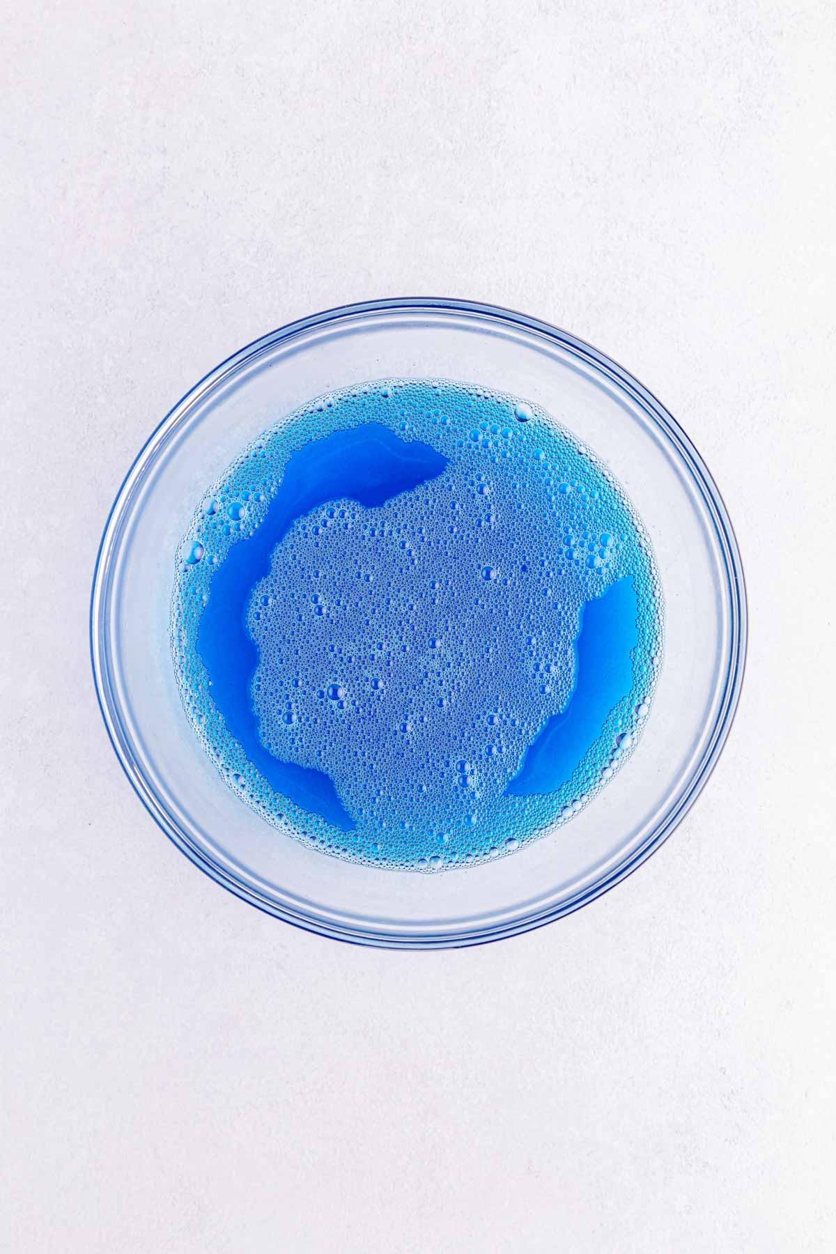 blue jello in a glass bowl