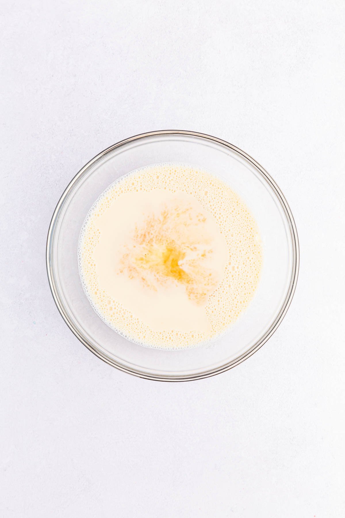 white creamy jello mixture in a glass bowl