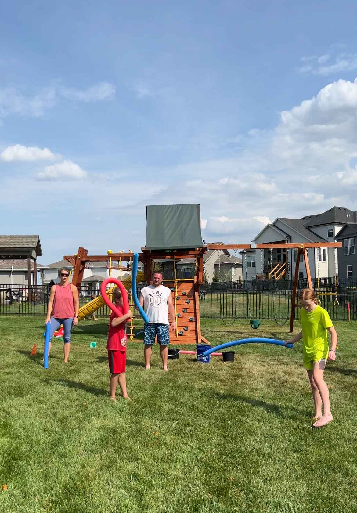 a family holding pool noodles