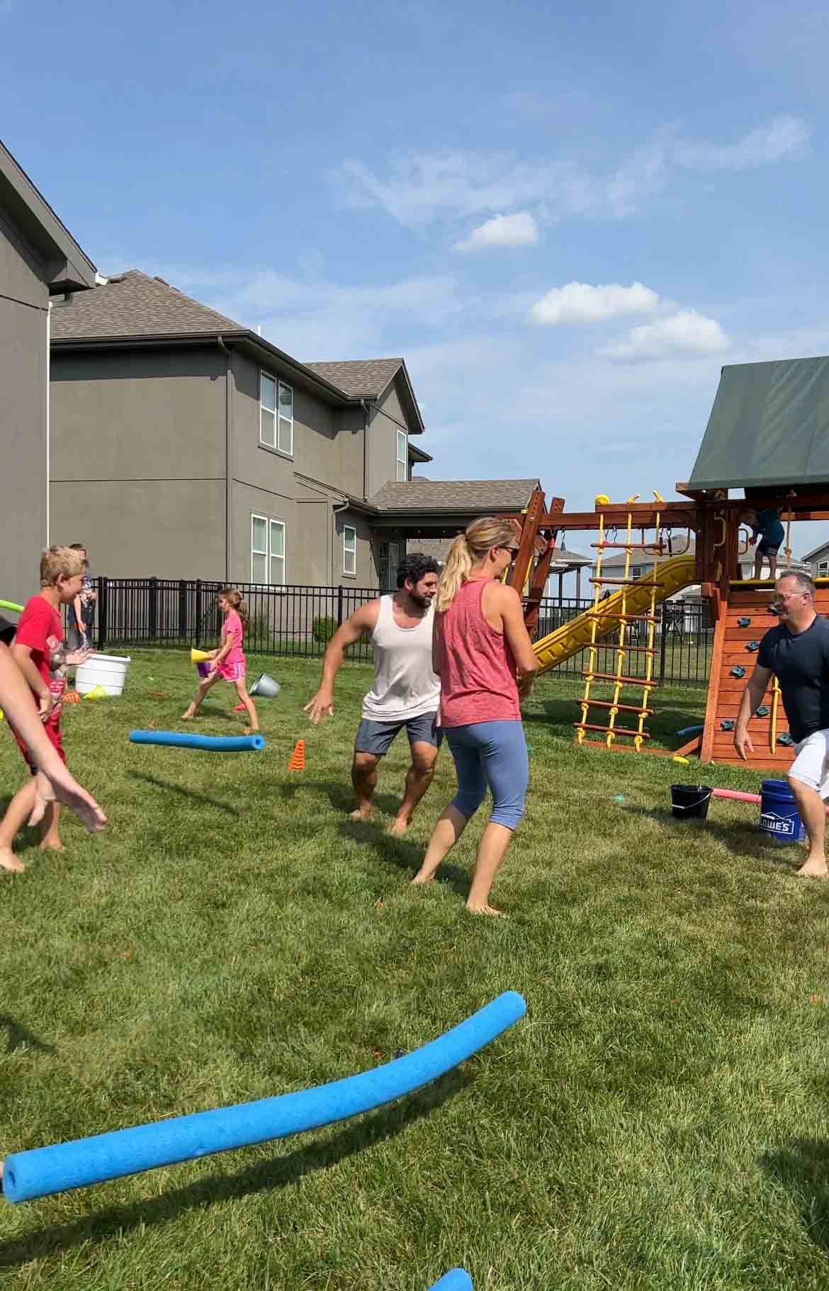 people standing by a pool noodle on the ground