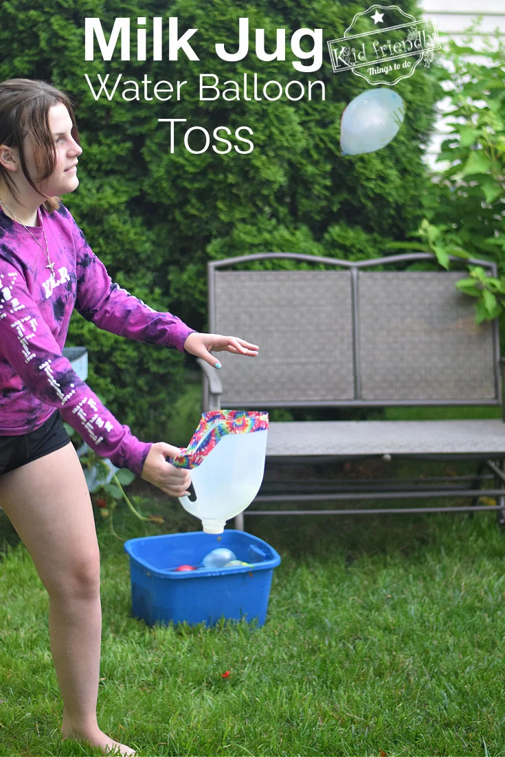 girl holding a cut milk jug while playing water balloon games