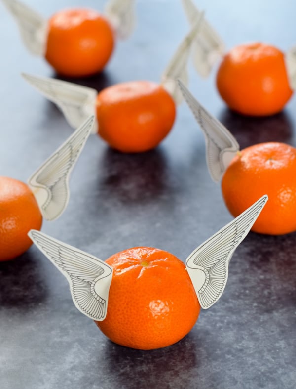 oranges with printable wings stuck in the sides