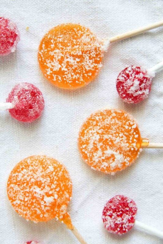 various colors and sizes of lollipops coated in sugar