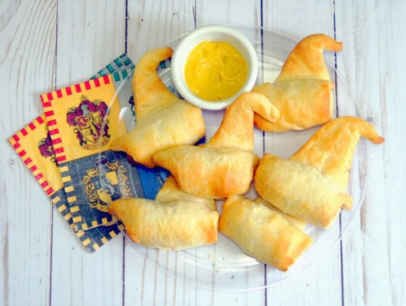 pigs in a blanket that have a corner unwrapped and look like a witch's hat
