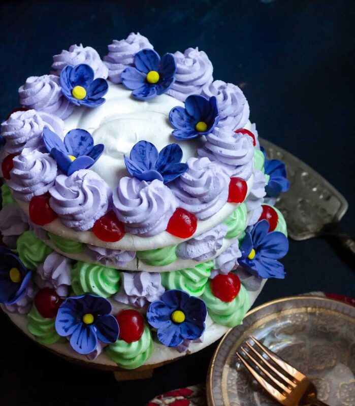 layered merengue cake with decorative flowers