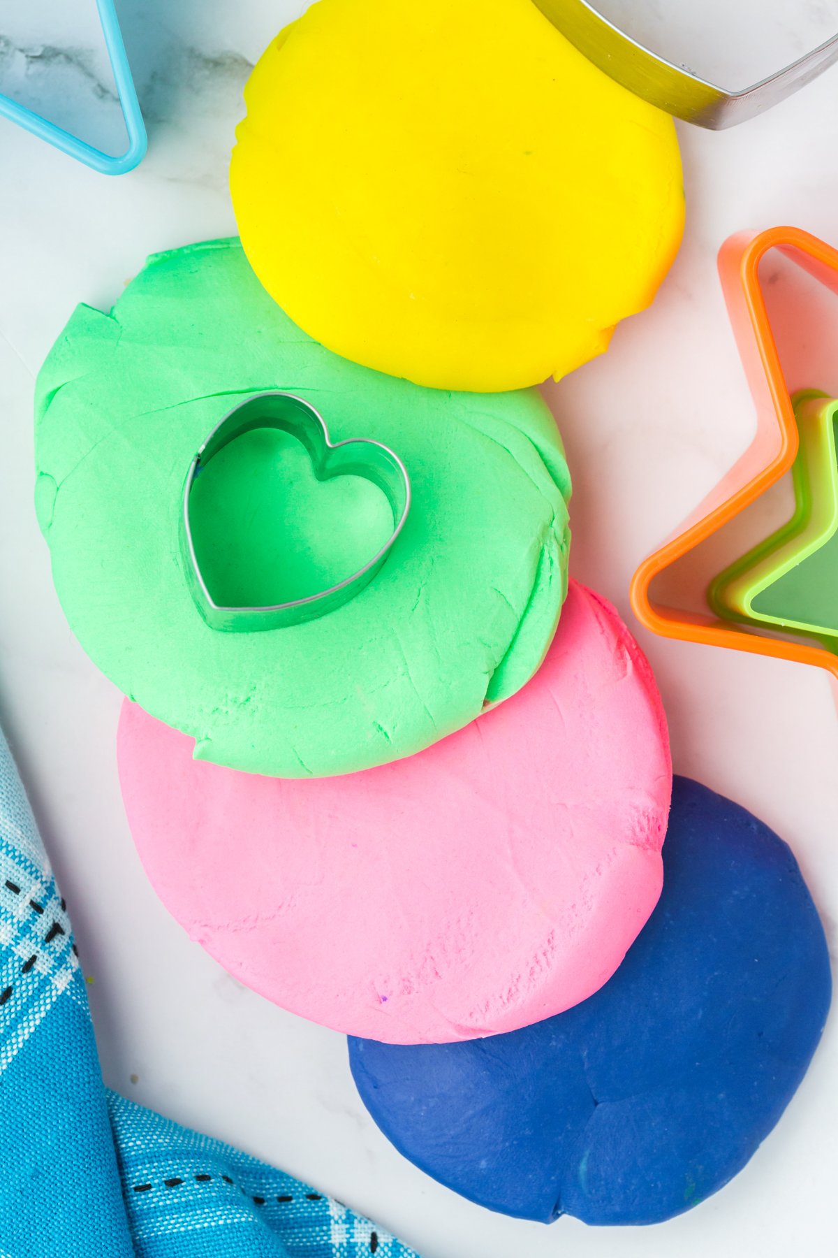 rolled out edible playdough in various colors