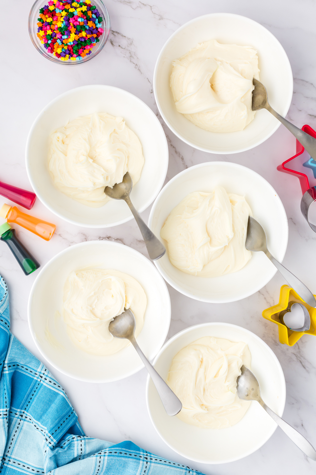 five bowls with white frosting 