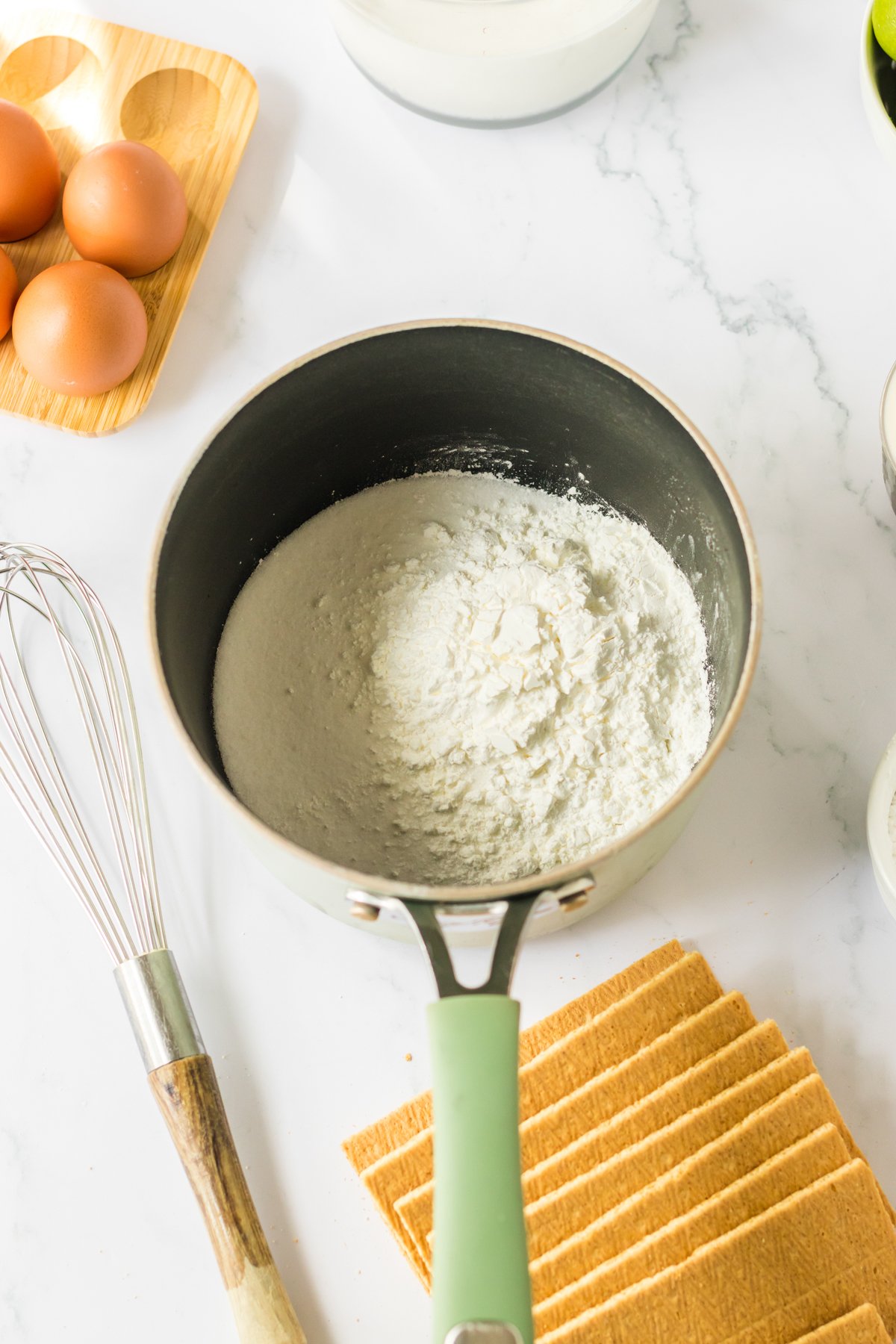 saucepan with ingredients for key lime ice box cake