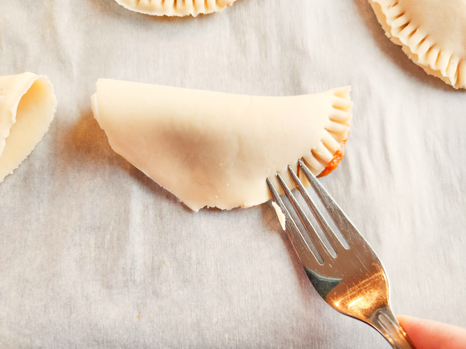 sealing pumpkin pasties with a fork