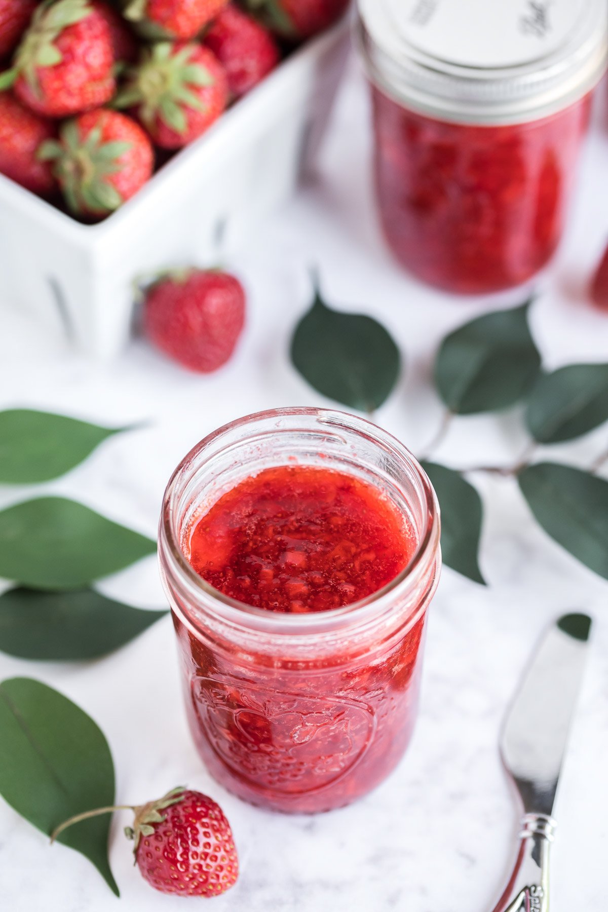 glass mason jar with strawberry freezer jam