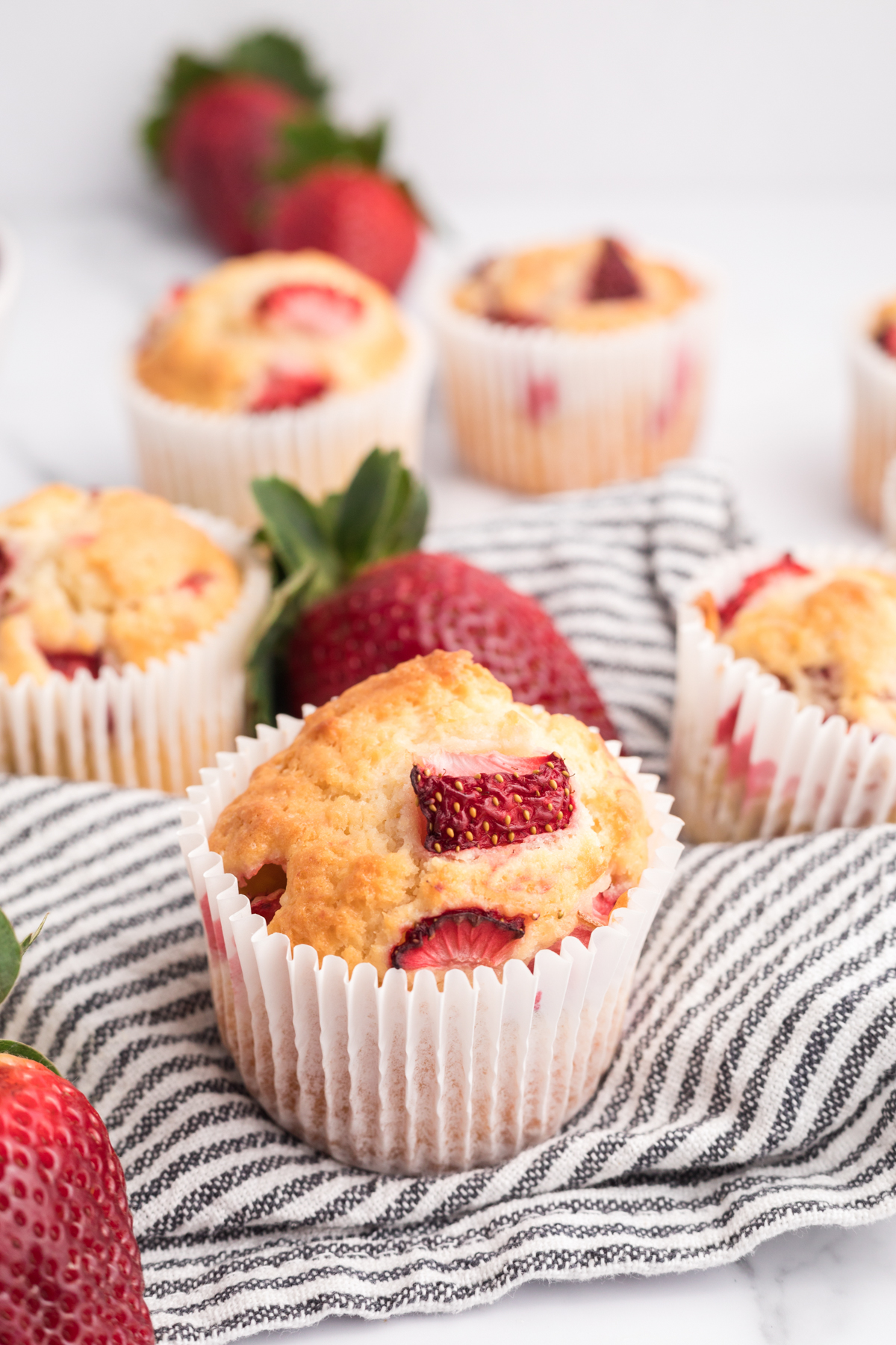 strawberry muffin in a white cupcake wrapper