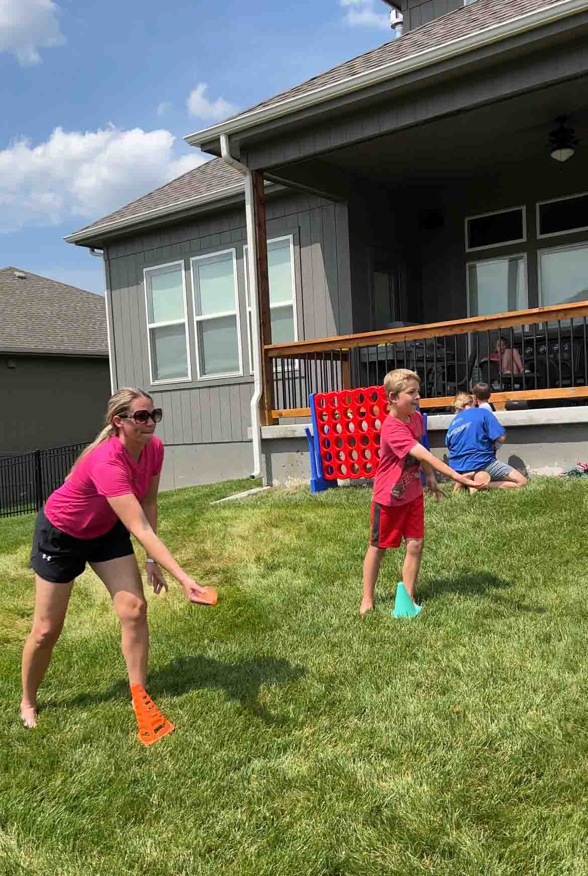 woman and child tossing water balloons