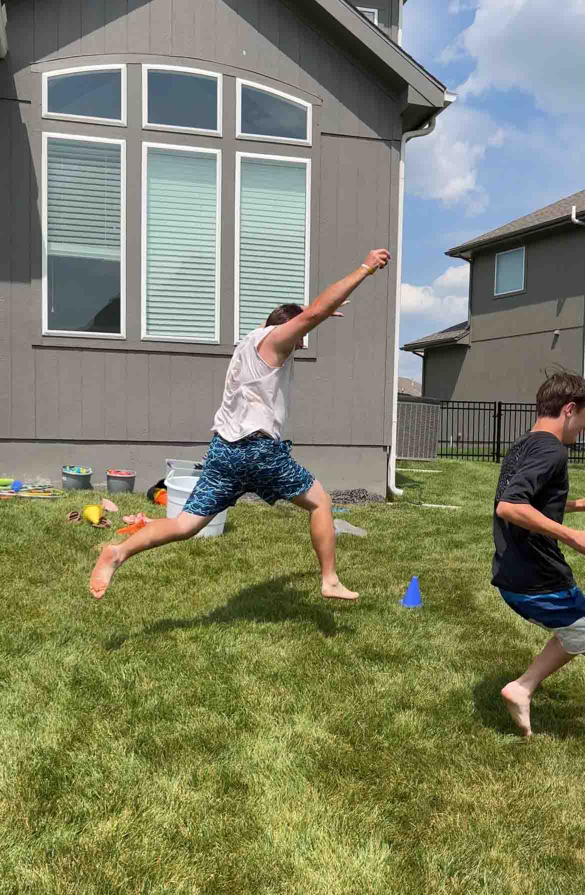 man jumping to get back during water balloon games