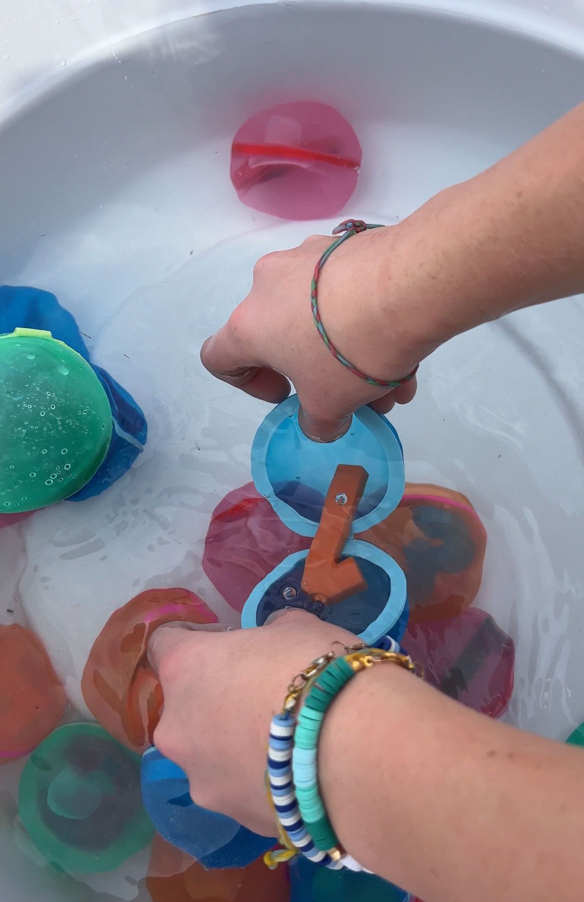 woman holding a water balloon with a number in it