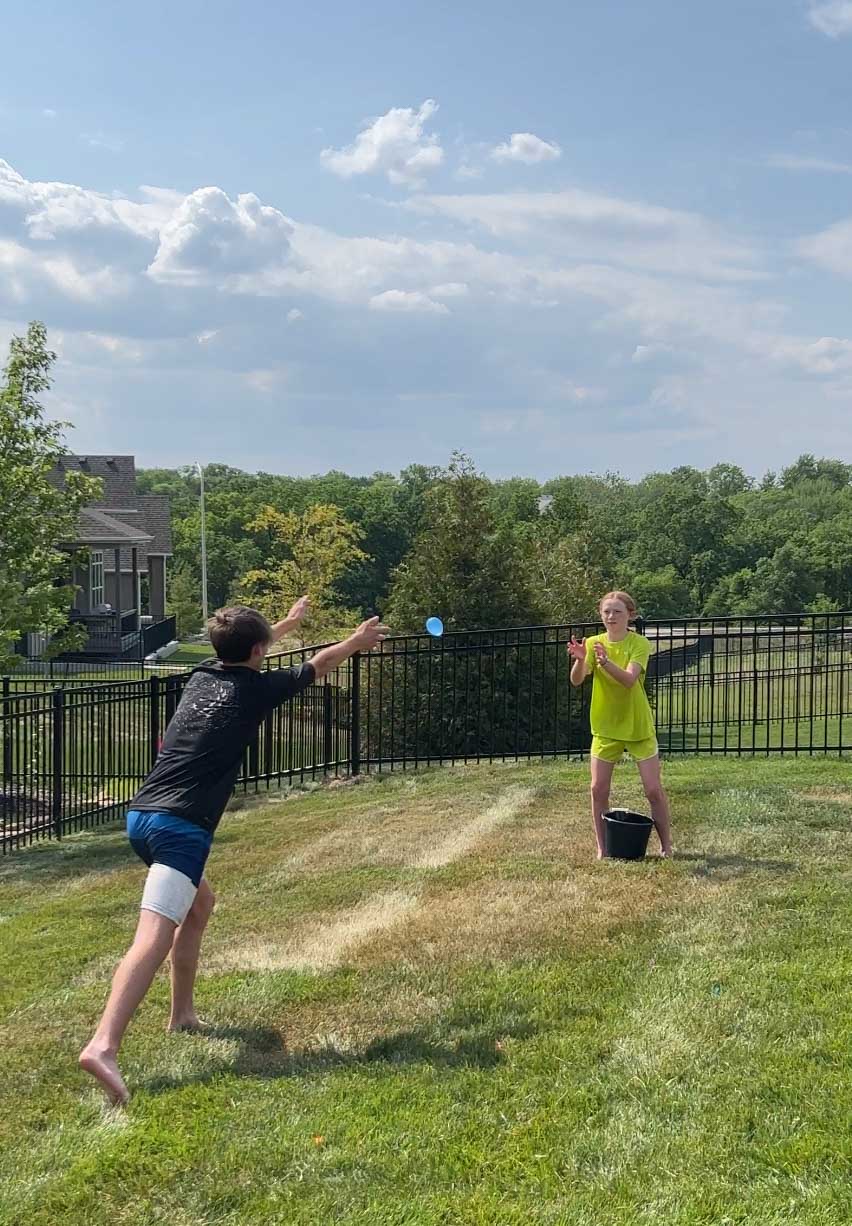 kids tossing water balloons to each other