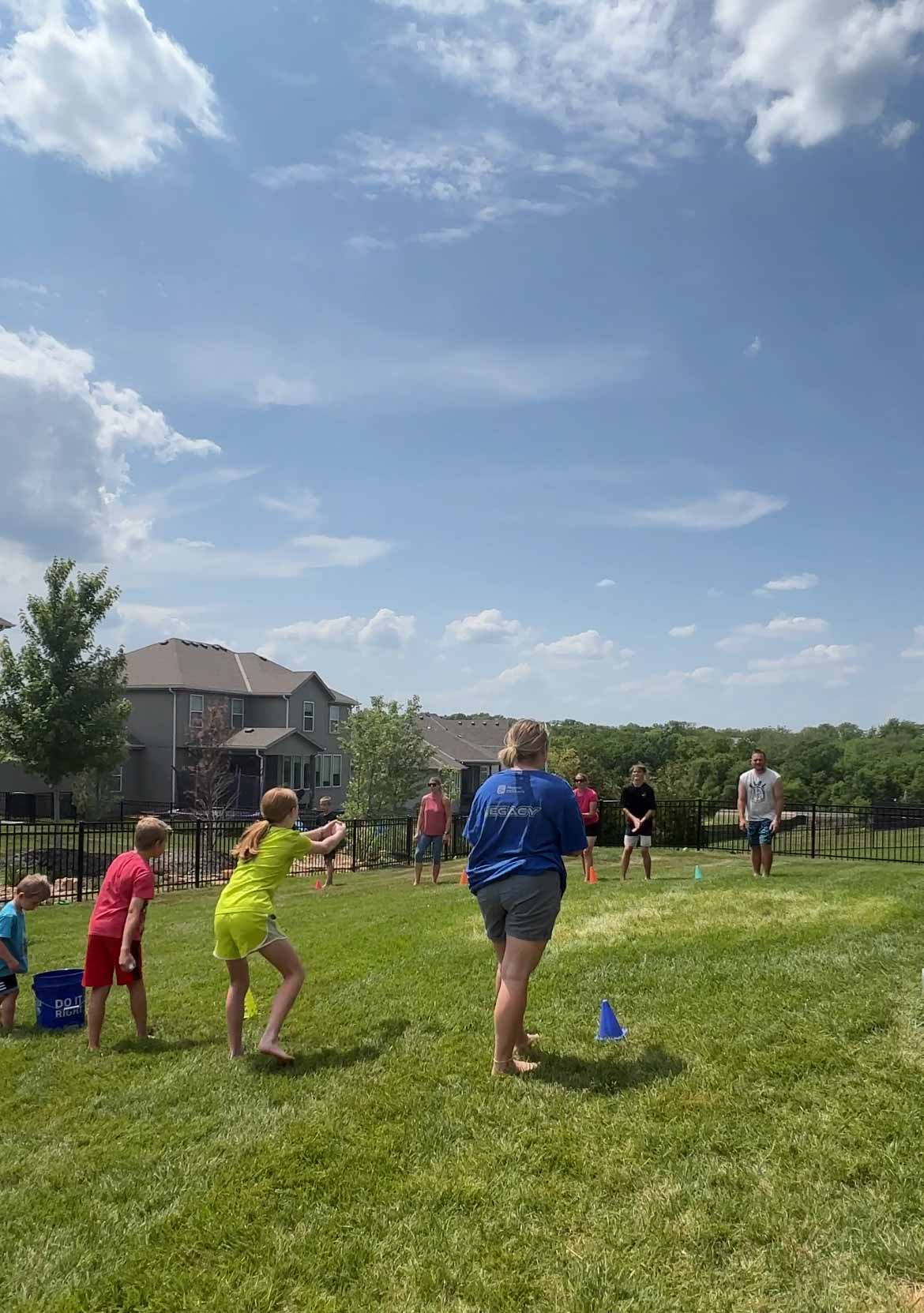 adults doing a water balloon toss